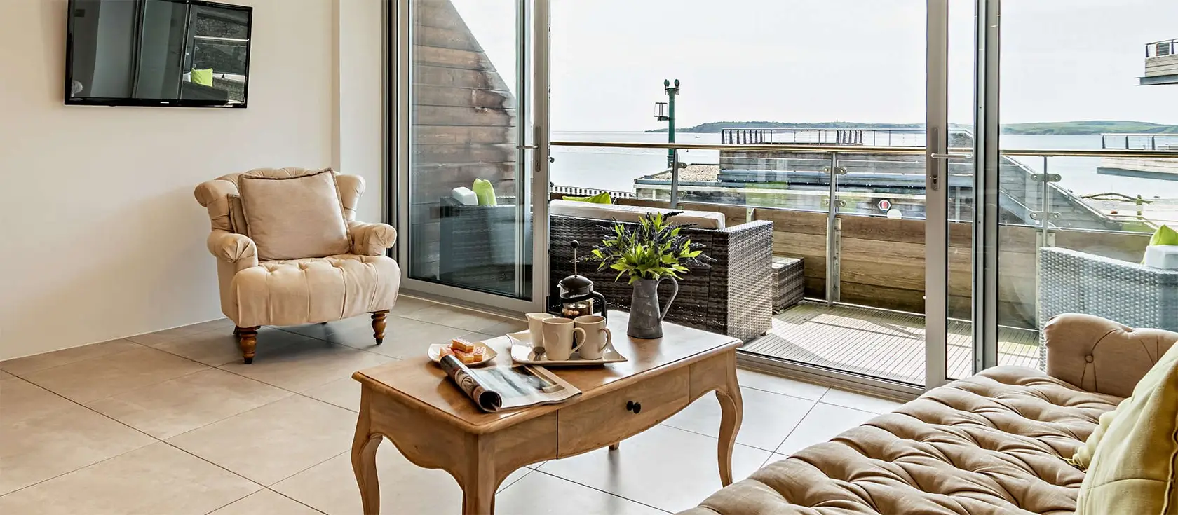 11 Waters Edge, Tenby is a deluxe 2-bedroom first-floor retreat with contemporary furnishings, stunning views of Tenby South Beach, and easy access to local attractions, ideal for couples or families seeking indulgence during their seaside getaway.
