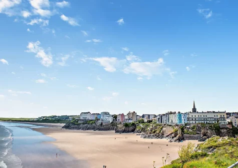 Tenby's North Beach is a long sandy beach set against a backdrop of cliffs on one side and Tenby town & the picturesque harbour on the other