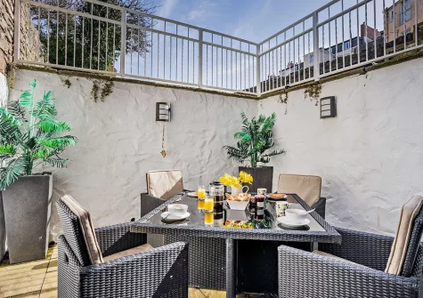 The patio & alfresco dining area at Caldey View 1, Tenby