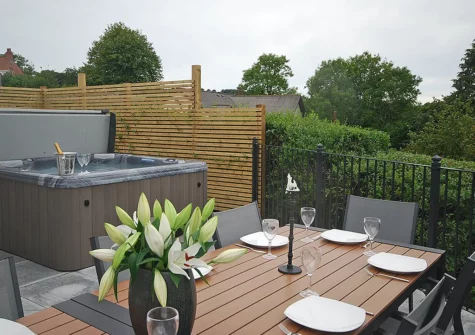 The patio, alfresco dining area & hot tub at Coastal Nest, Saundersfoot