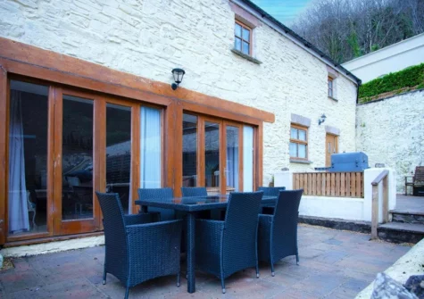 The patio & alfresco dining area at Fletcher Coach House, Llanmiloe