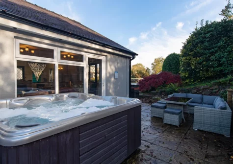 The hot tub & alfresco dining area at Hazelglade Cottage, Saundersfoot