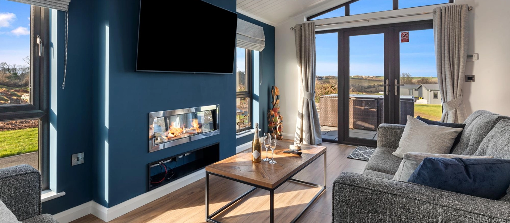 Hiraeth is a stylish contemporary lodge in the village of Penally, a short walk or drive from lively Tenby. This bright, airy property features an open-plan living area, two king-size bedrooms, two bathrooms, a furnished terrace and a hot tub.