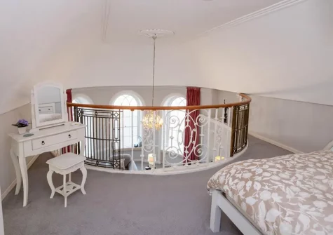 Bedroom #1 is galleried with a balcony overlooking the living room
