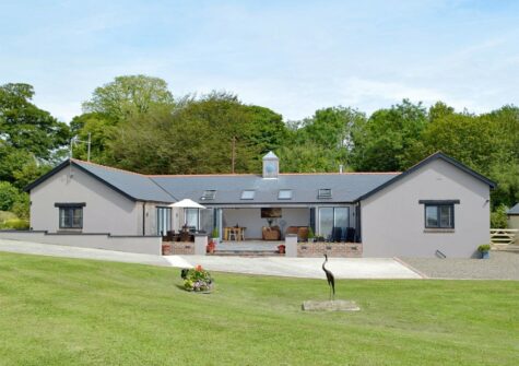 Manor Lodge Stables, Wiston near Narberth is a luxury renovated stables with four bedrooms & three bathrooms (one ensuite). Bright, open plan living with woodburner & bi-fold doors onto sheltered terrace. Private garden, parking & panoramic views.