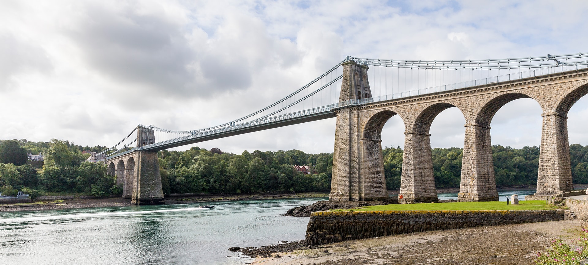 In 1819, a civil engineer called Thomas Telford began working on ambitious improvements to journey between London and the port of Holyhead. Recognising the danger to travellers that crossing the Straits involved, Telford designed a groundbreaking piece of civil engineering – the Menai Bridge. Completed on 30 January 1826, the Menai Bridge was a triumph of civil engineering – the biggest suspension bridge in the world at the time.