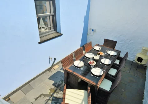 The enclosed rear patio & alfresco dining area at Millbank Cottage, Llanstadwell