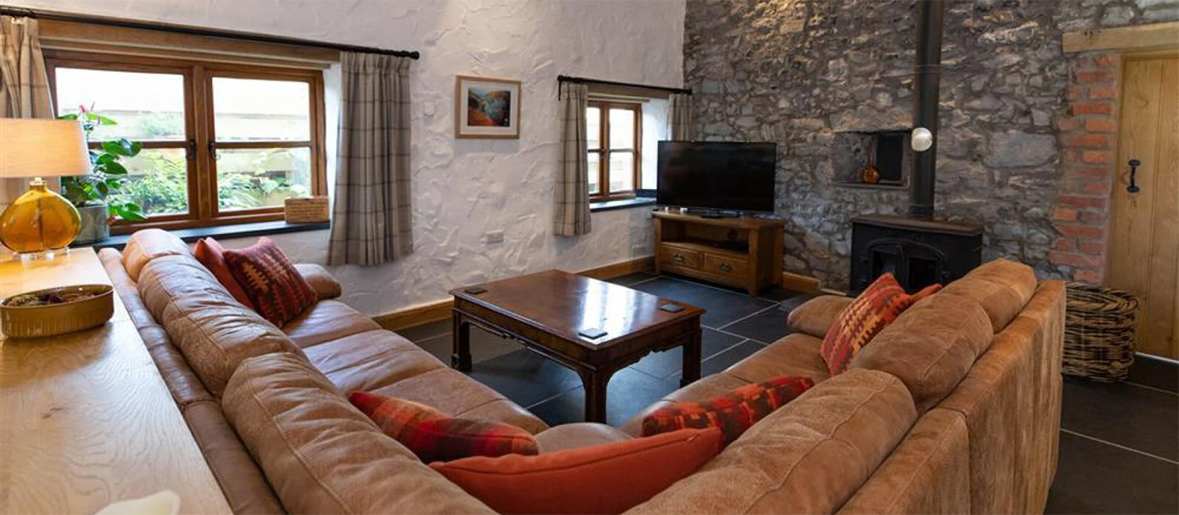 Orchard Barn, St Florence is a beautifully designed barn conversion with many architectural features. Three bedrooms (one with four-poster and ensuite), open-plan living room with woodburner & gourmet kitchen. Large garden with rural views near Tenby.