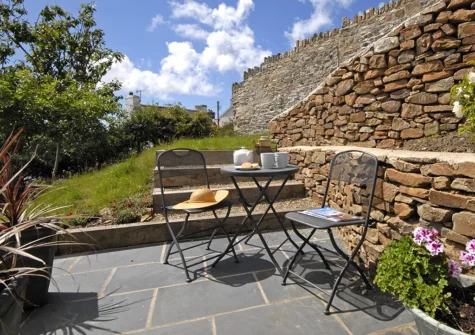The secluded patio outside bedroom #1 at Oswald House, Little Haven