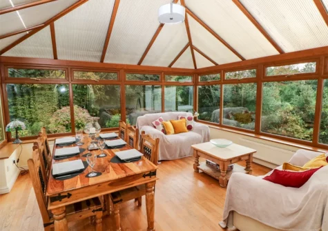 The conservatory dining area at Pen Y Daith, Stepaside