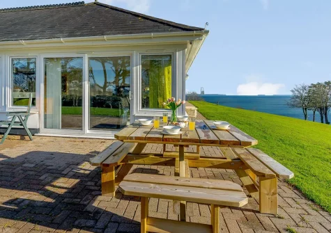 The patio, alfresco dining area & garden at Pine View, Tenby