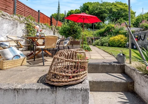 The patio, alfresco dining area & garden at Quarry Cottages 3, Tenby
