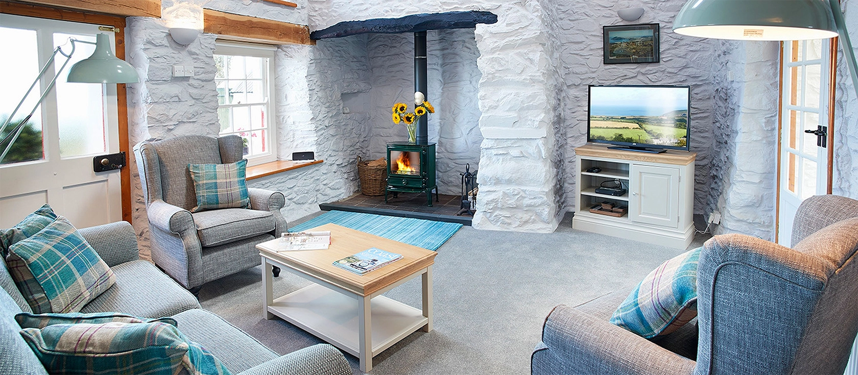 Rhiwelli, Dinas Cross sits in large grounds in the Preseli Hills and enjoys stunning coastal views from its patio and garden. This two-bedroom cottage blends modern comfort with characterful original features and has plenty of space for four people.