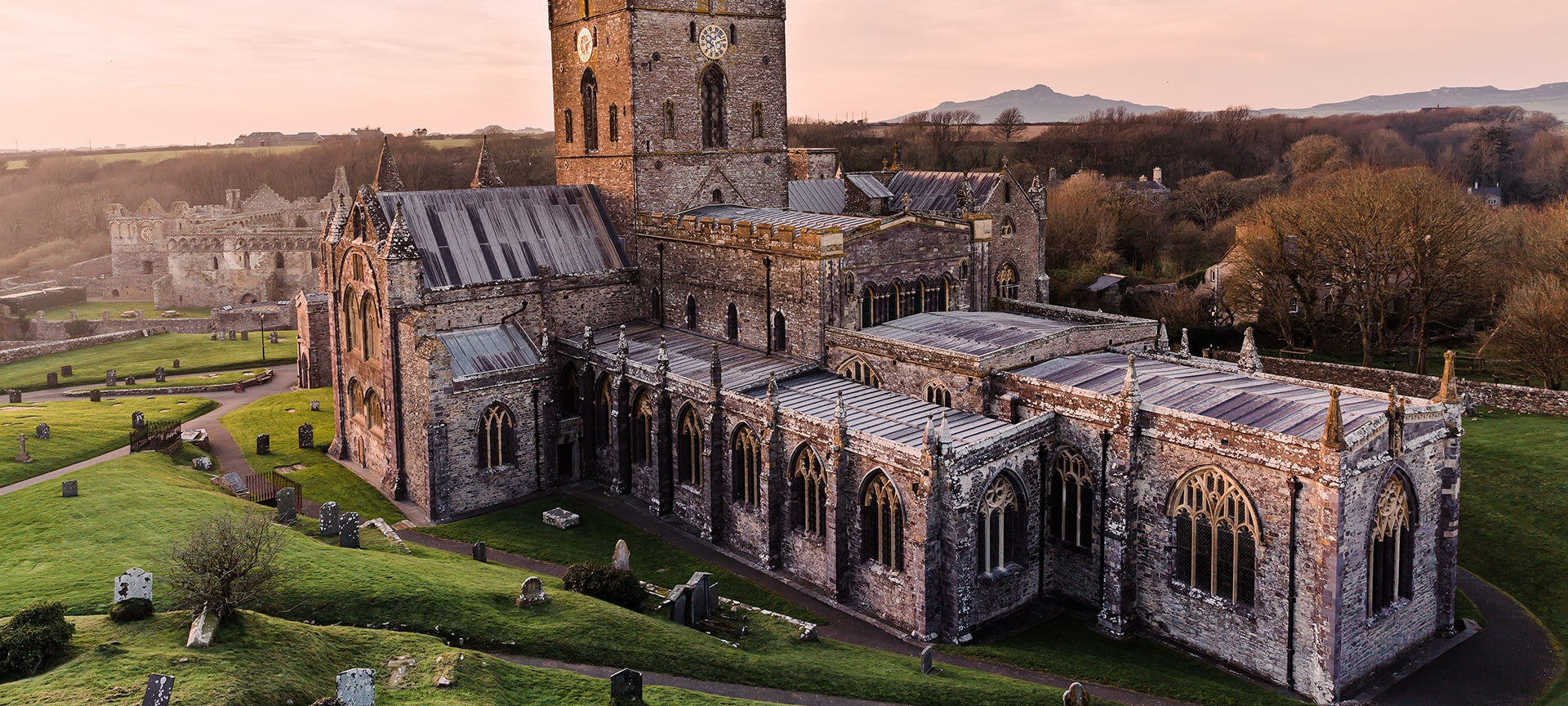 St Davids is one of the great historic shrines of Christendom. Nowhere in Britain is there a more ancient cathedral settlement, for it reaches back fourteen centuries and survived the plunder of the Norsmen in the 'Dark Ages'. St David chose this wild, beautiful region as the site of his monastery in the 6th century and you will find his shrine in the purple-stoned cathedral, which nestles inconspicuously in a grassy hollow beneath the rooftops of the tiny city.