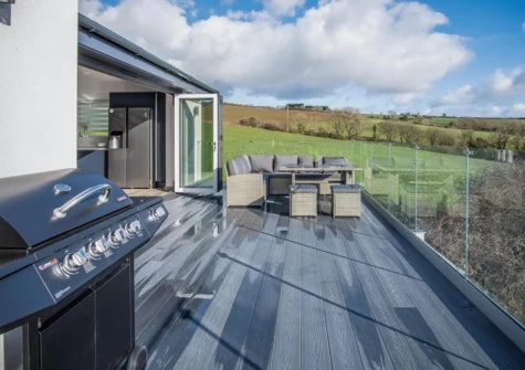 The upper patio, barbeque & alfresco dining area at Sunrise, Pendine