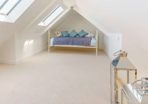 Climb the small wooden staircase up to the mezzanine level, where you will find a daybed for extra seating