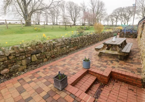 The front patio & garden at The Barn at Harrolds Farm, Redberth
