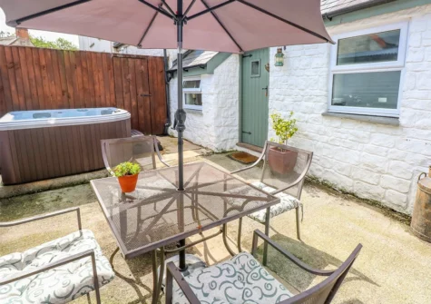 The courtyard, alfresco dining area & hot tub at The Barn at Waunlippa, Llan-mill