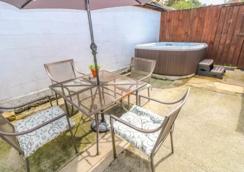 The courtyard, alfresco dining area & hot tub at The Barn at Waunlippa, Llan-mill