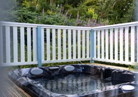 The wrap-around verandah & sunken hot tub at The Bluebell, Penally