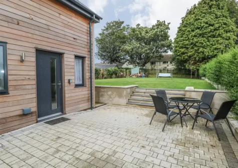 The patio, alfresco dining area & garden at The Boathouse, Tenby