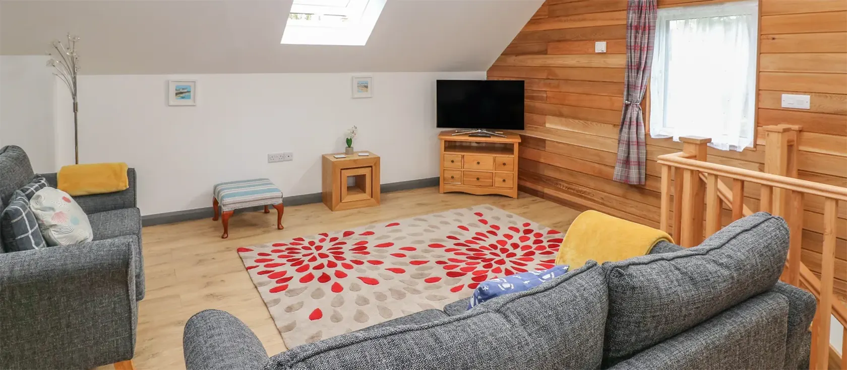 The Boathouse is a fantastic modern property in a peaceful area of Tenby. This contemporary wooden lodge features spacious living areas, two interconnected bedrooms with flexible beds, two bathrooms, a large lawned garden with a patio, and parking.