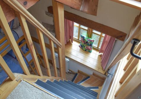 Stairs leading to a galleried seating area from bedroom #3 at The Byre, Lyserry Barns, St Twynnells