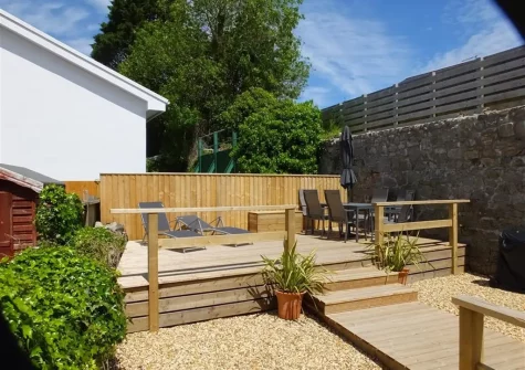 The decked patio, alfresco dining & outdoor sitting area at Ty Carreg, Tenby