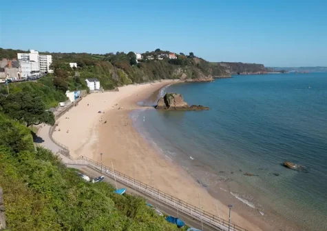 Tenby's North Beach is a long sandy beach set against a backdrop of cliffs on one side and Tenby town & the picturesque harbour on the other