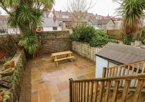 Ty Cwtch's decked patio leads down to the patio & alfresco dining area