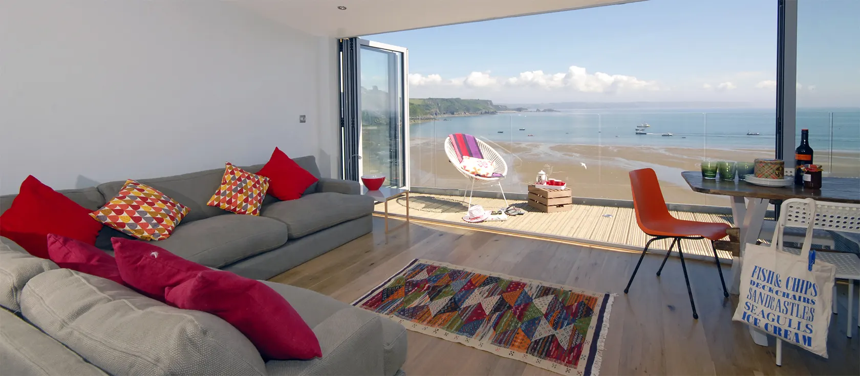 Ty Mair, Tenby is a four bedroom, three bathroom townhouse. Stunning harbour/beach views from deck & sitting room with bi-fold doors. Walk to pubs, shops & beach.