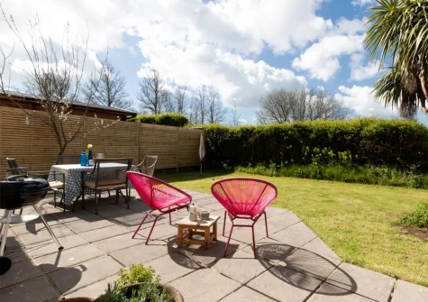 The patio, alfresco dining area & garden at Woodfield House, Tenby
